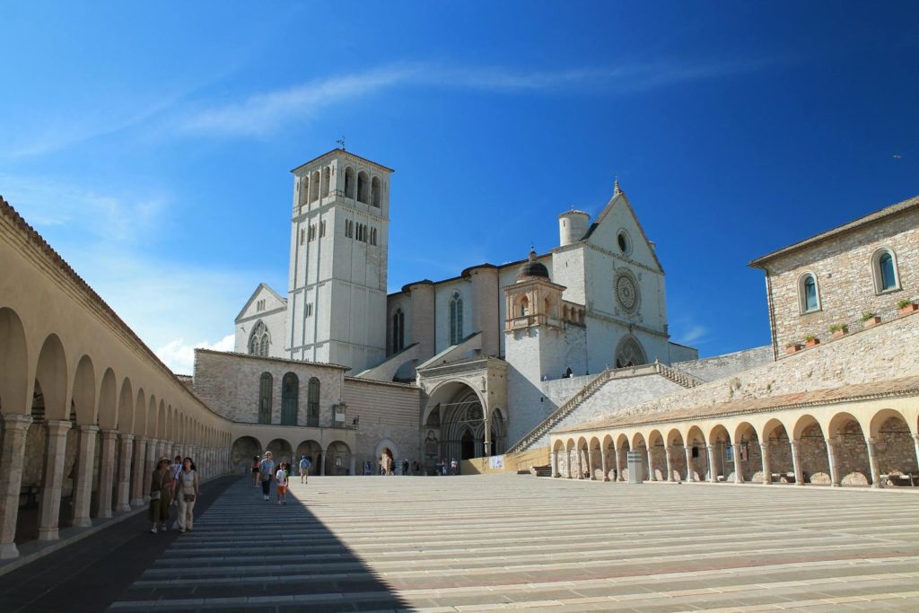 Scenic view of the Basilica of Saint Francis in Assisi with clear blue skies.