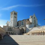 Scenic view of the Basilica of Saint Francis in Assisi with clear blue skies.
