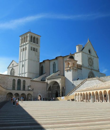Scenic view of the Basilica of Saint Francis in Assisi with clear blue skies.