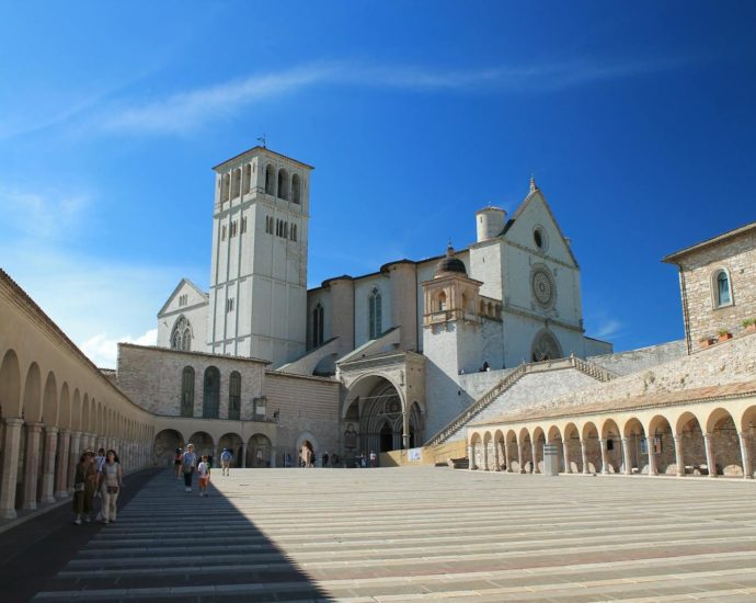Scenic view of the Basilica of Saint Francis in Assisi with clear blue skies.